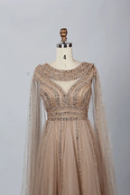 Gold-toned beaded boat-neck A-line dress with long sleeves, close-up