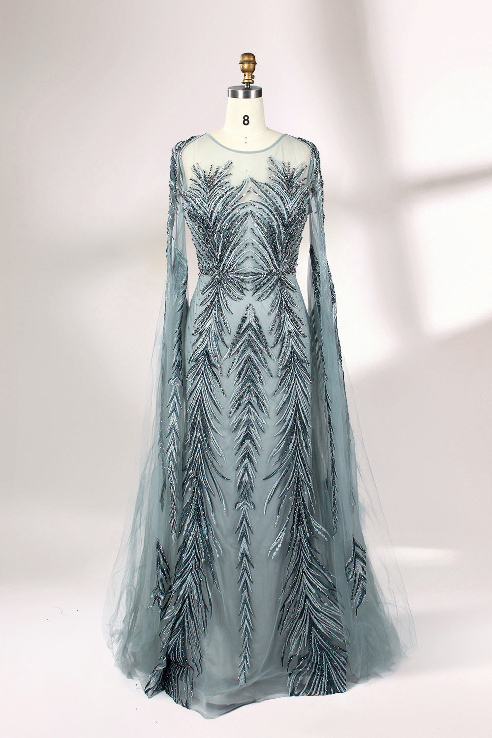 Showcased on a mannequin is a light - teal evening gown. It features a sheer high - neck design, long flowing sleeves, and intricate leaf - pattern embroidery. The gown's elegant and unique design exudes a sense of sophistication and grace, making it an ideal choice for formal events.
1