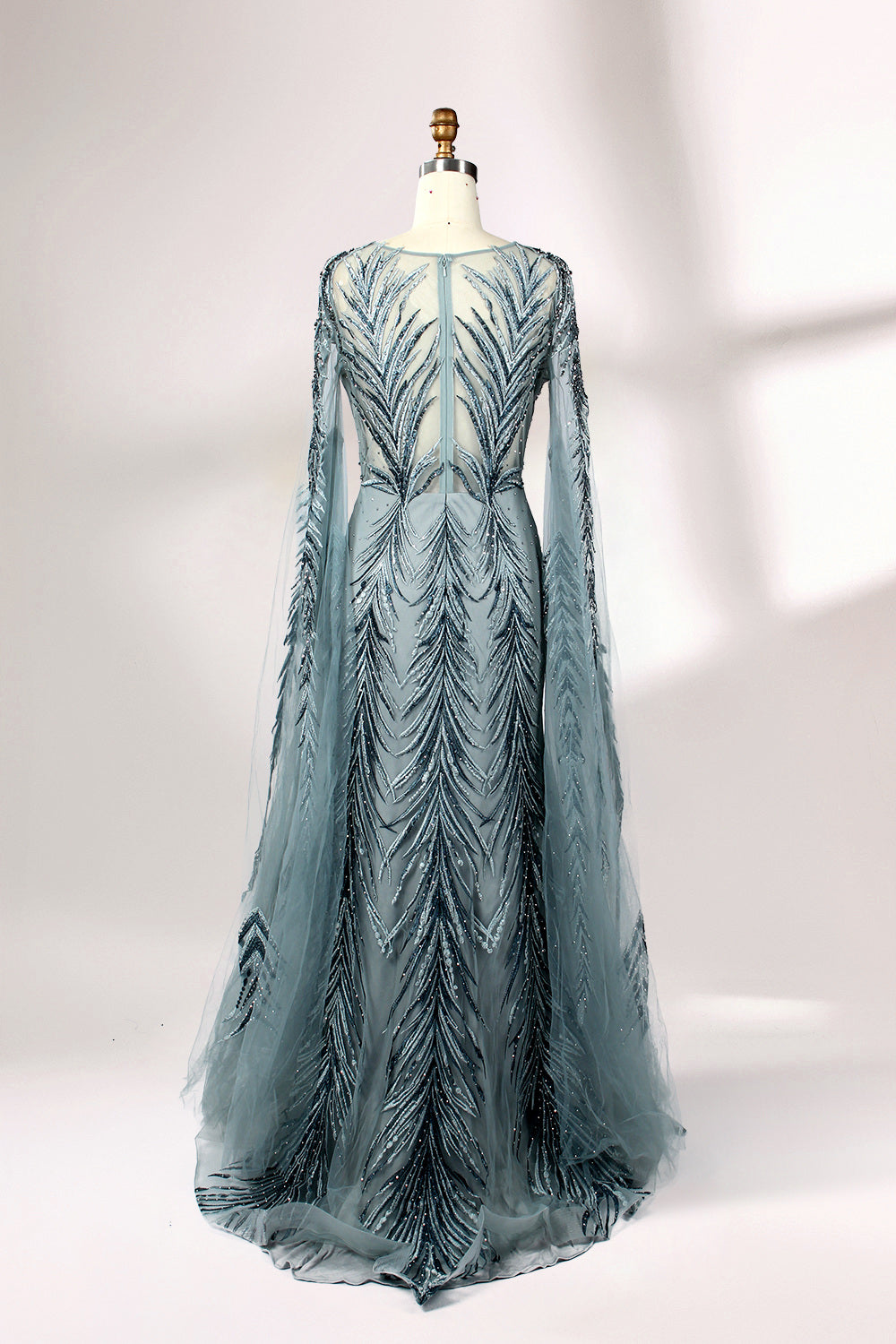 Showcased on a mannequin is a light - teal evening gown. It features a sheer high - neck design, long flowing sleeves, and intricate leaf - pattern embroidery. The gown's elegant and unique design exudes a sense of sophistication and grace, making it an ideal choice for formal events.
2