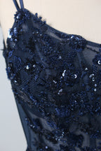 This is a floor - length evening dress in a deep navy hue. It has a strapless style with thin shoulder straps. The bodice is embellished with delicate beadwork and embroidery, creating an elegant and glamorous look. The skirt is form - fitting around the hips and flows down to the floor, featuring a side slit that adds allure and allows for easy movement. Displayed on a mannequin against a simple, light - colored backdrop, the dress exudes sophistication, perfect for special occasions like galas or proms.04