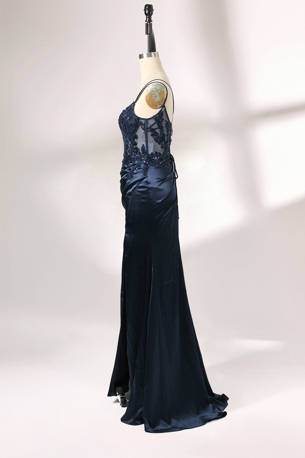 This is a floor - length evening dress in a deep navy hue. It has a strapless style with thin shoulder straps. The bodice is embellished with delicate beadwork and embroidery, creating an elegant and glamorous look. The skirt is form - fitting around the hips and flows down to the floor, featuring a side slit that adds allure and allows for easy movement. Displayed on a mannequin against a simple, light - colored backdrop, the dress exudes sophistication, perfect for special occasions like galas or proms.05