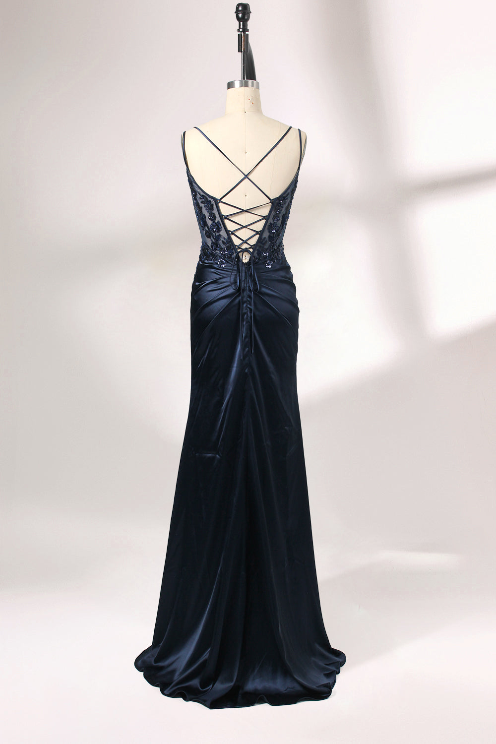 This is a floor - length evening dress in a deep navy hue. It has a strapless style with thin shoulder straps. The bodice is embellished with delicate beadwork and embroidery, creating an elegant and glamorous look. The skirt is form - fitting around the hips and flows down to the floor, featuring a side slit that adds allure and allows for easy movement. Displayed on a mannequin against a simple, light - colored backdrop, the dress exudes sophistication, perfect for special occasions like galas or proms.02