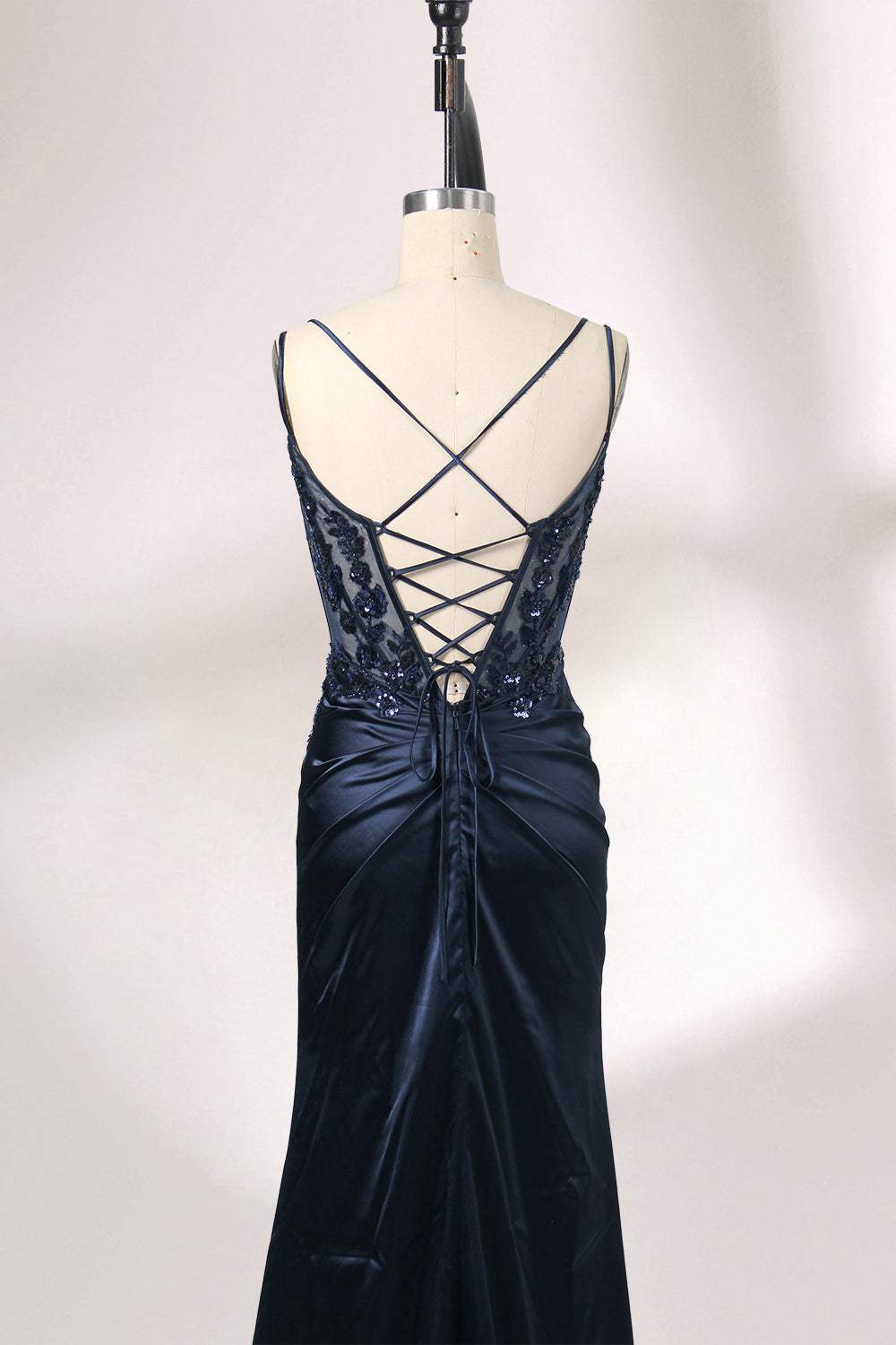 This is a floor - length evening dress in a deep navy hue. It has a strapless style with thin shoulder straps. The bodice is embellished with delicate beadwork and embroidery, creating an elegant and glamorous look. The skirt is form - fitting around the hips and flows down to the floor, featuring a side slit that adds allure and allows for easy movement. Displayed on a mannequin against a simple, light - colored backdrop, the dress exudes sophistication, perfect for special occasions like galas or proms.06