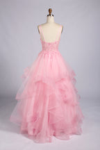 Rear view of pink lace bodice A-line prom dress with spaghetti straps and tulle ruffles