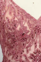 Photograph of a mannequin showcasing a floor-length, sleeveless, pink tulle gown with intricate lace detailing on the bodice and neckline. The gown features a fitted waist and flares out into a voluminous skirt, creating a ballerina-style silhouette. The mannequin stands against a plain white background with soft, diffused lighting casting subtle shadows.05