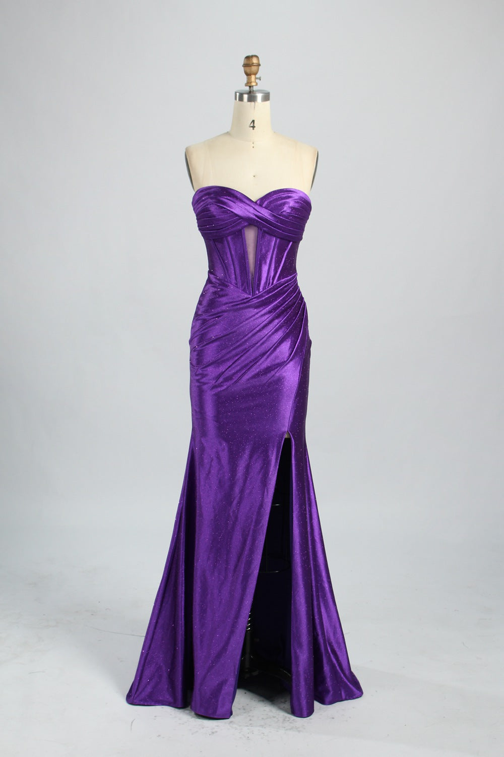 This is a strapless royal - blue gown. It features a twisted - front design at the bustline, with a sheer panel in the middle of the bodice. The waist is cinched with ruched detailing, and the skirt is mermaid - shaped with a high side slit. Paired with silver - glittered heels, it exudes elegance and sensuality, perfect for formal events like galas or balls.7