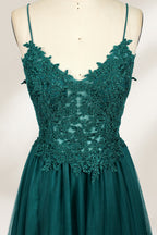 A mannequin showcases a dark - green tulle gown. It has thin spaghetti straps, a lace - detailed bodice, and a voluminous, flowing skirt. The elegant design, with its romantic tulle and delicate lace, suits formal events like galas or weddings.1