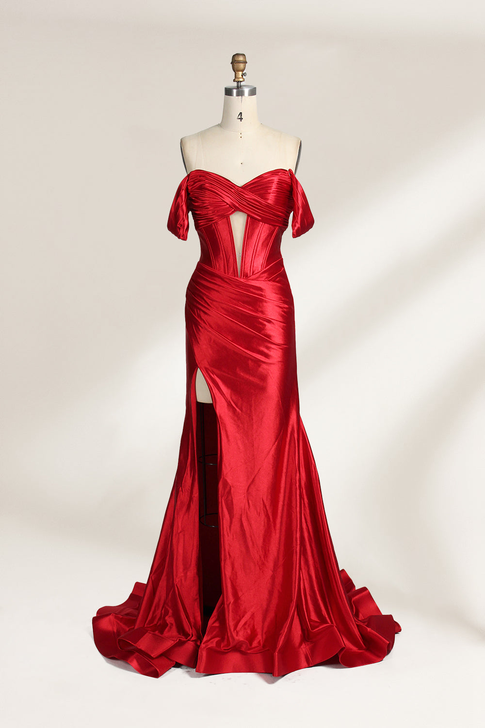  mannequin showcases a strapless red satin gown against a light - hued backdrop. It features an off - shoulder, twisted bodice with a sheer panel and a high side slit. The smooth satin fabric and elegant silhouette radiate sophistication, ideal for formal dinners or charity balls.1