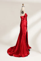  mannequin showcases a strapless red satin gown against a light - hued backdrop. It features an off - shoulder, twisted bodice with a sheer panel and a high side slit. The smooth satin fabric and elegant silhouette radiate sophistication, ideal for formal dinners or charity balls.