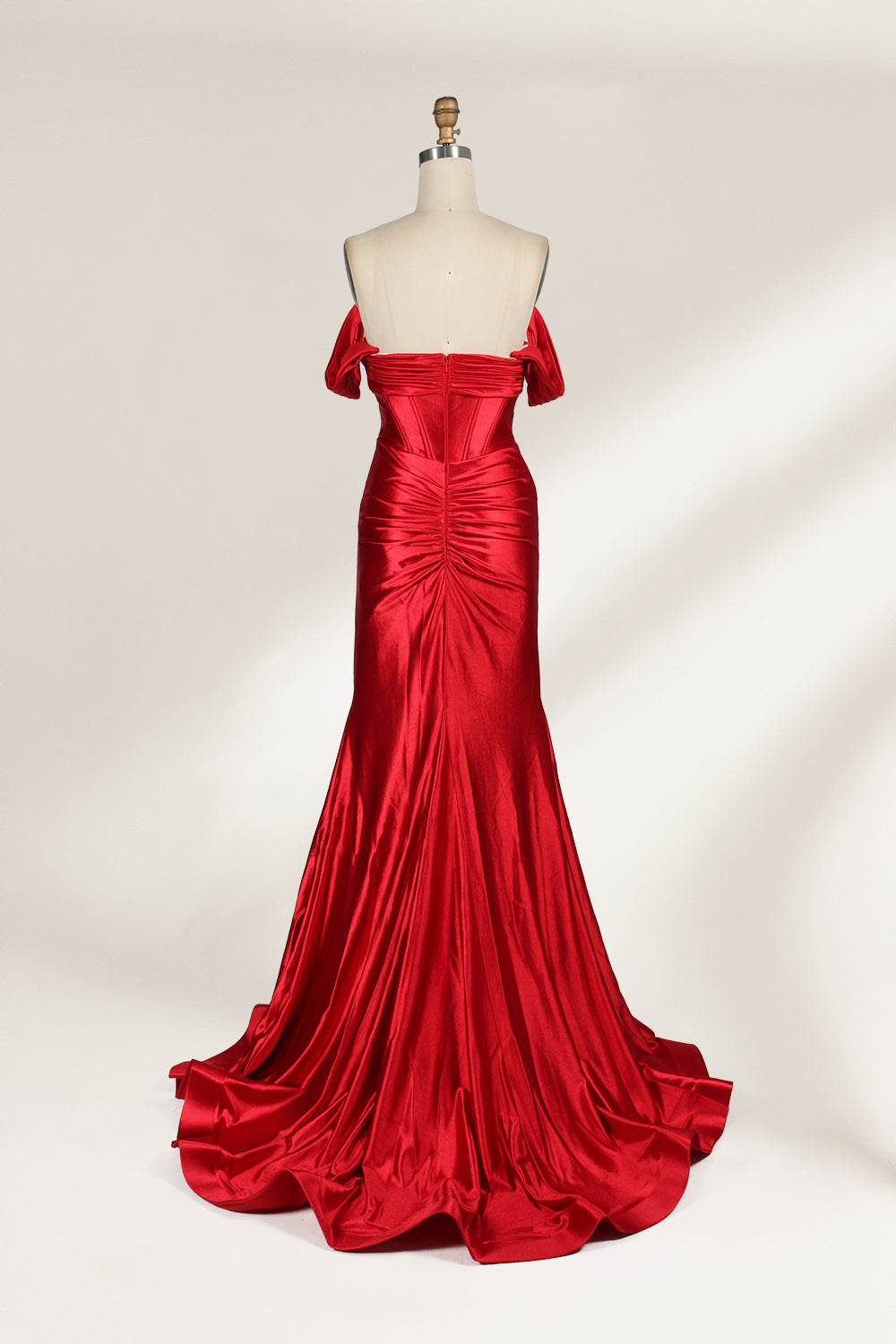  mannequin showcases a strapless red satin gown against a light - hued backdrop. It features an off - shoulder, twisted bodice with a sheer panel and a high side slit. The smooth satin fabric and elegant silhouette radiate sophistication, ideal for formal dinners or charity balls.2