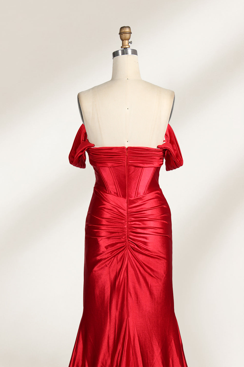  mannequin showcases a strapless red satin gown against a light - hued backdrop. It features an off - shoulder, twisted bodice with a sheer panel and a high side slit. The smooth satin fabric and elegant silhouette radiate sophistication, ideal for formal dinners or charity balls.6