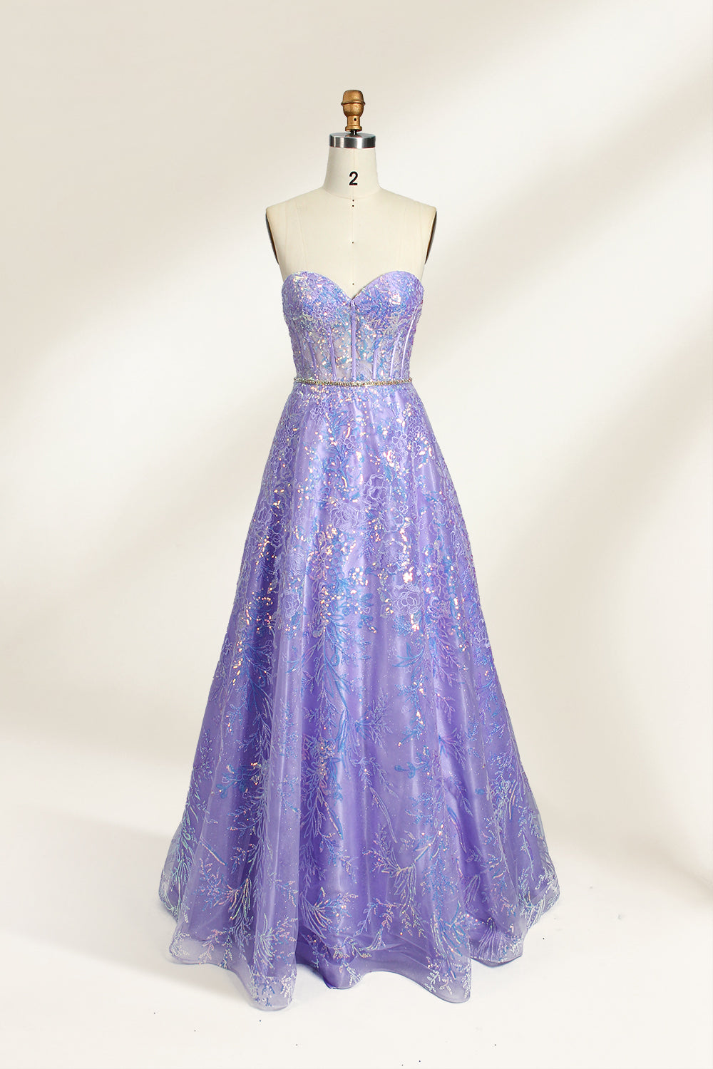 This is a purple evening gown. It has a strapless, sweetheart neckline. The bodice features intricate patterns, cinched at the waist with a thin belt. The floor - length skirt, made of tulle, is covered in iridescent embroidery. Perfect for formal events, it exudes elegance and a dreamy vibe.01