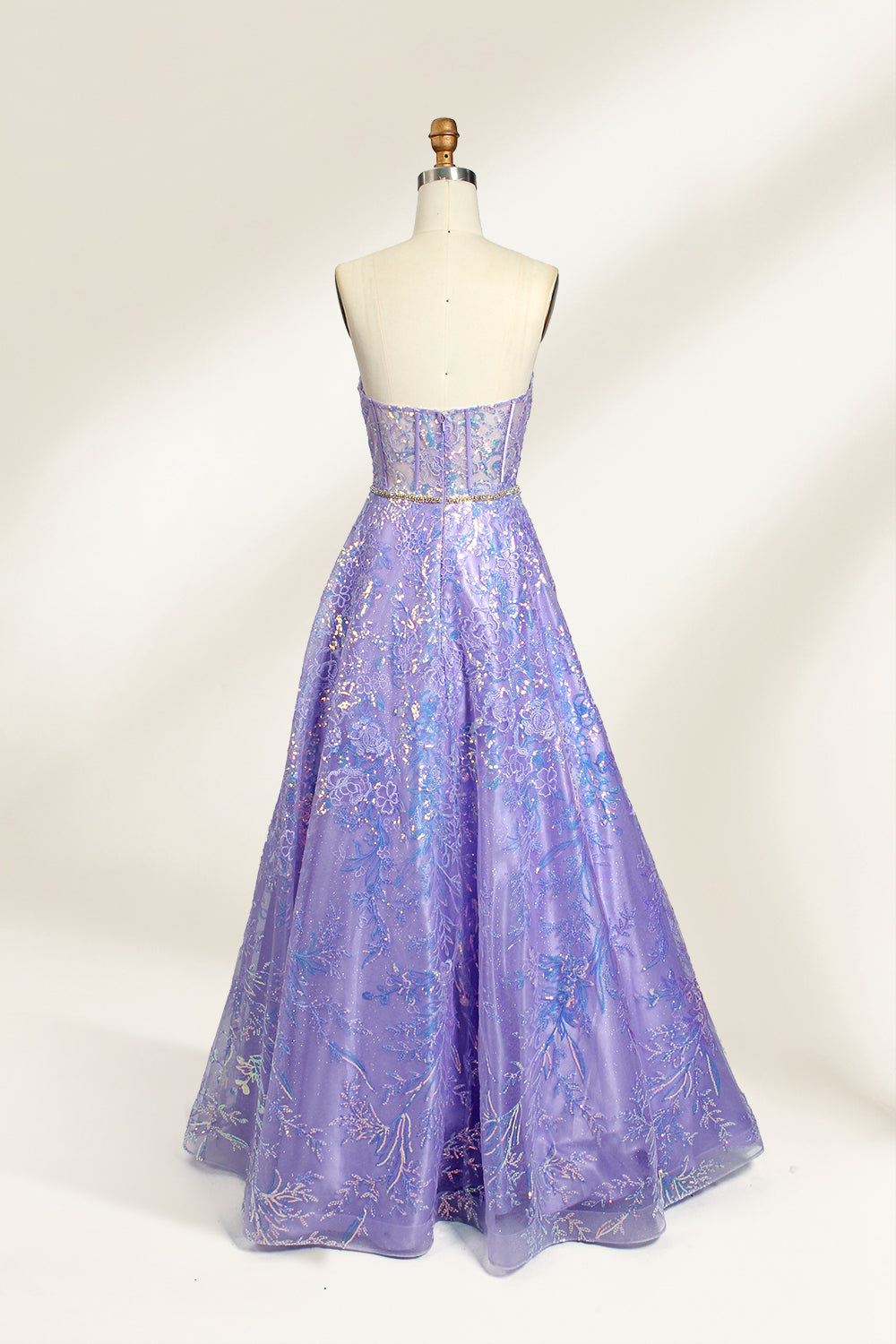 This is a purple evening gown. It has a strapless, sweetheart neckline. The bodice features intricate patterns, cinched at the waist with a thin belt. The floor - length skirt, made of tulle, is covered in iridescent embroidery. Perfect for formal events, it exudes elegance and a dreamy vibe.0