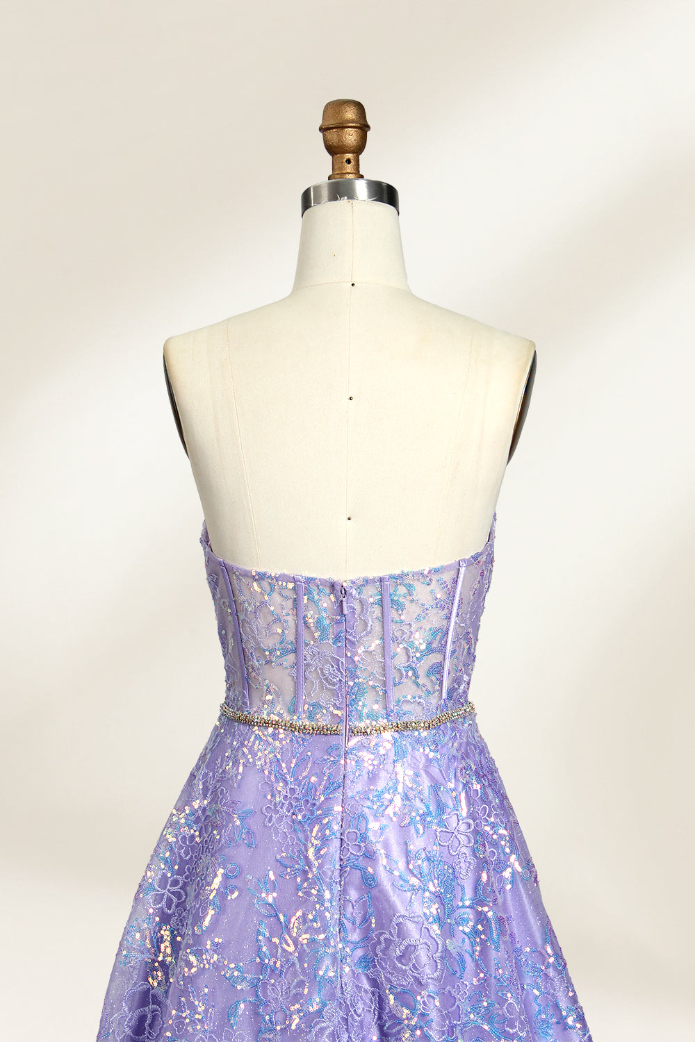 This is a purple evening gown. It has a strapless, sweetheart neckline. The bodice features intricate patterns, cinched at the waist with a thin belt. The floor - length skirt, made of tulle, is covered in iridescent embroidery. Perfect for formal events, it exudes elegance and a dreamy vibe.003