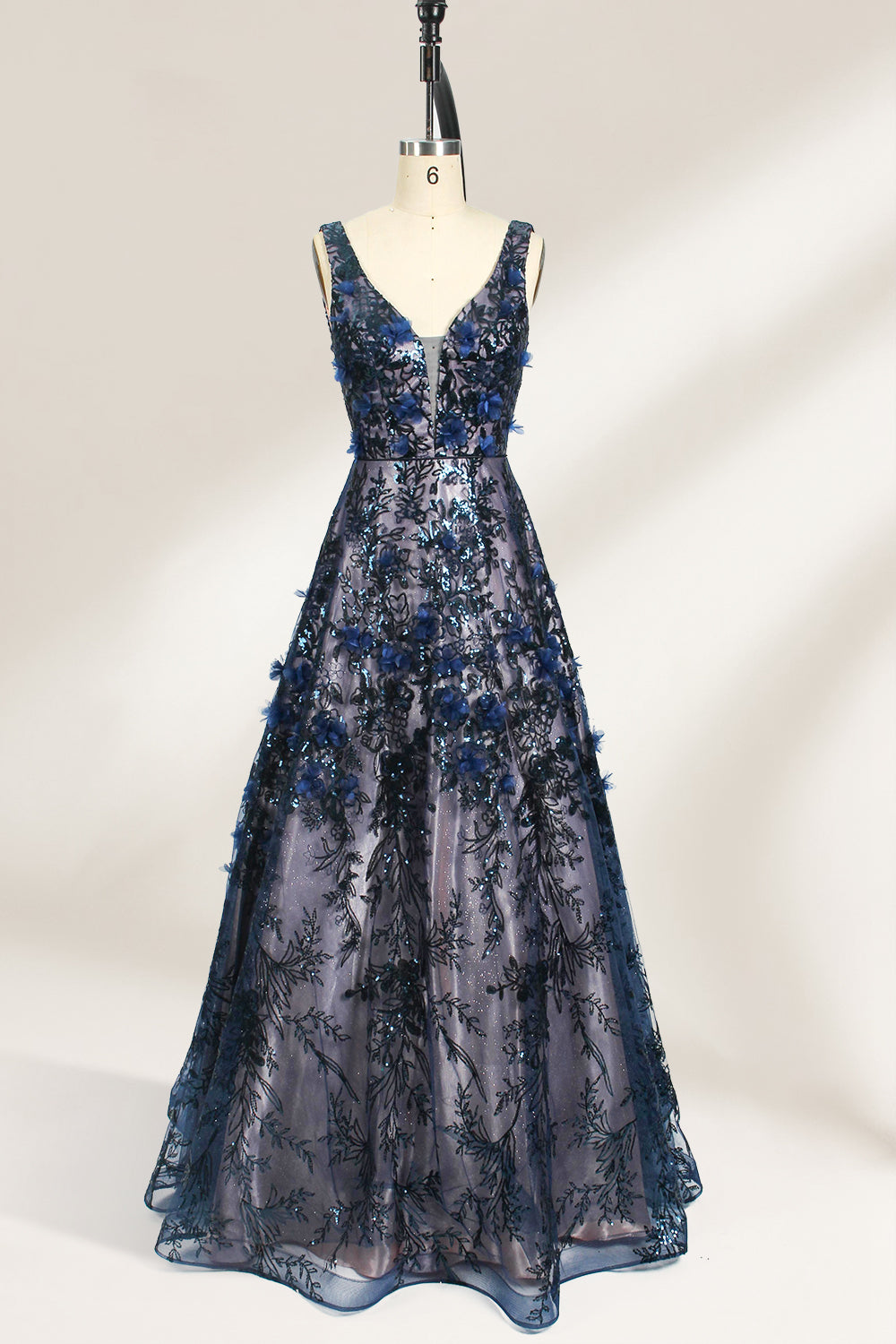 This is an evening gown displayed on a mannequin. It features a deep V - neckline and a sleeveless design. The dress is adorned with numerous blue three - dimensional floral embroideries and black patterns across the bodice and the floor - length skirt. The wide, trailing skirt creates an elegant and formal appearance, making it perfect for occasions such as dinners and balls.01