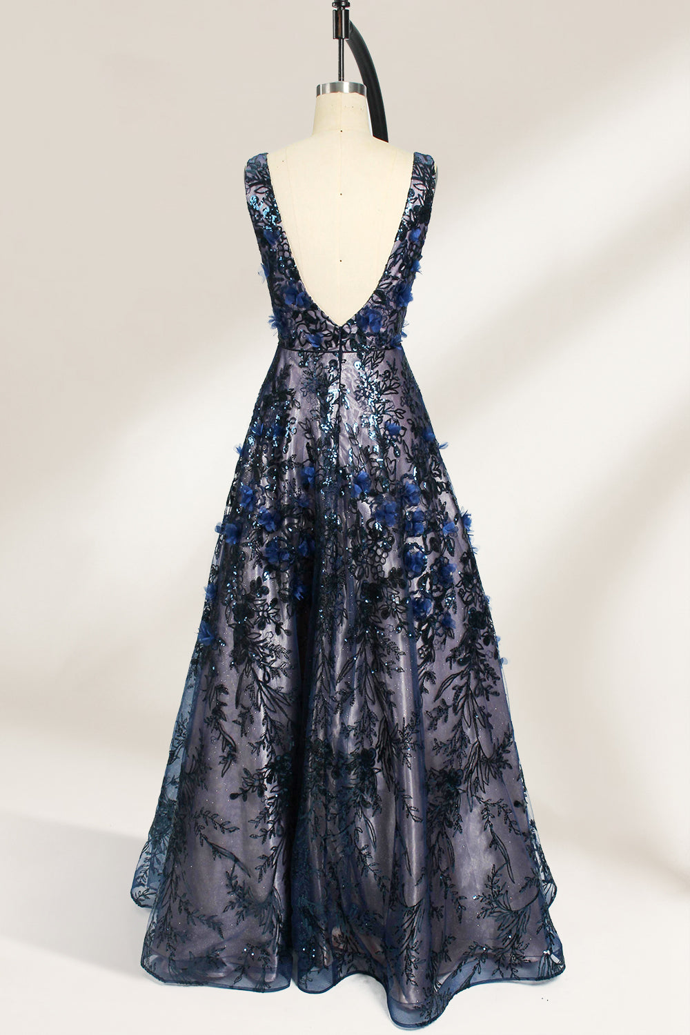 This is an evening gown displayed on a mannequin. It features a deep V - neckline and a sleeveless design. The dress is adorned with numerous blue three - dimensional floral embroideries and black patterns across the bodice and the floor - length skirt. The wide, trailing skirt creates an elegant and formal appearance, making it perfect for occasions such as dinners and balls.02
