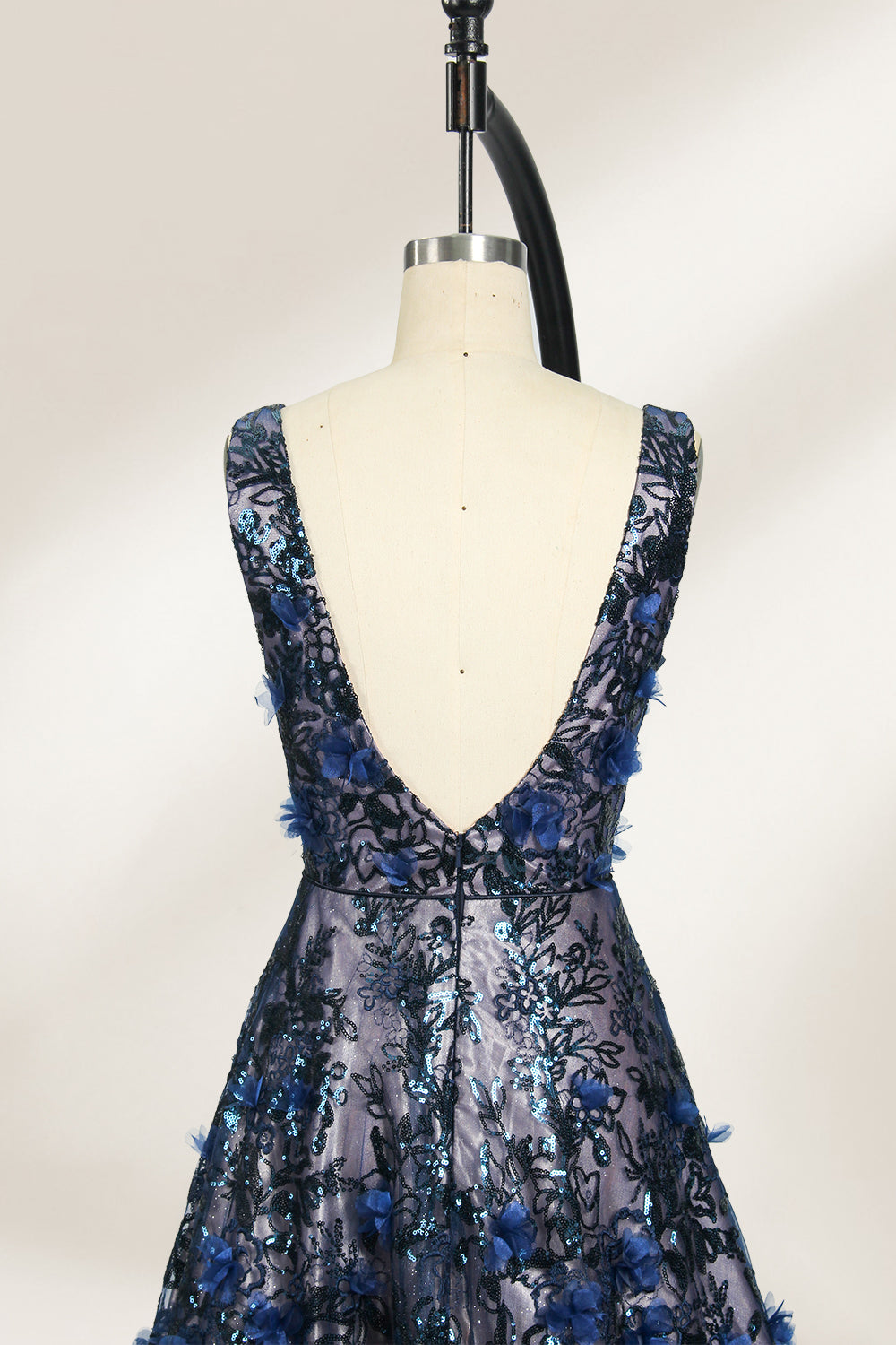 This is an evening gown displayed on a mannequin. It features a deep V - neckline and a sleeveless design. The dress is adorned with numerous blue three - dimensional floral embroideries and black patterns across the bodice and the floor - length skirt. The wide, trailing skirt creates an elegant and formal appearance, making it perfect for occasions such as dinners and balls.06