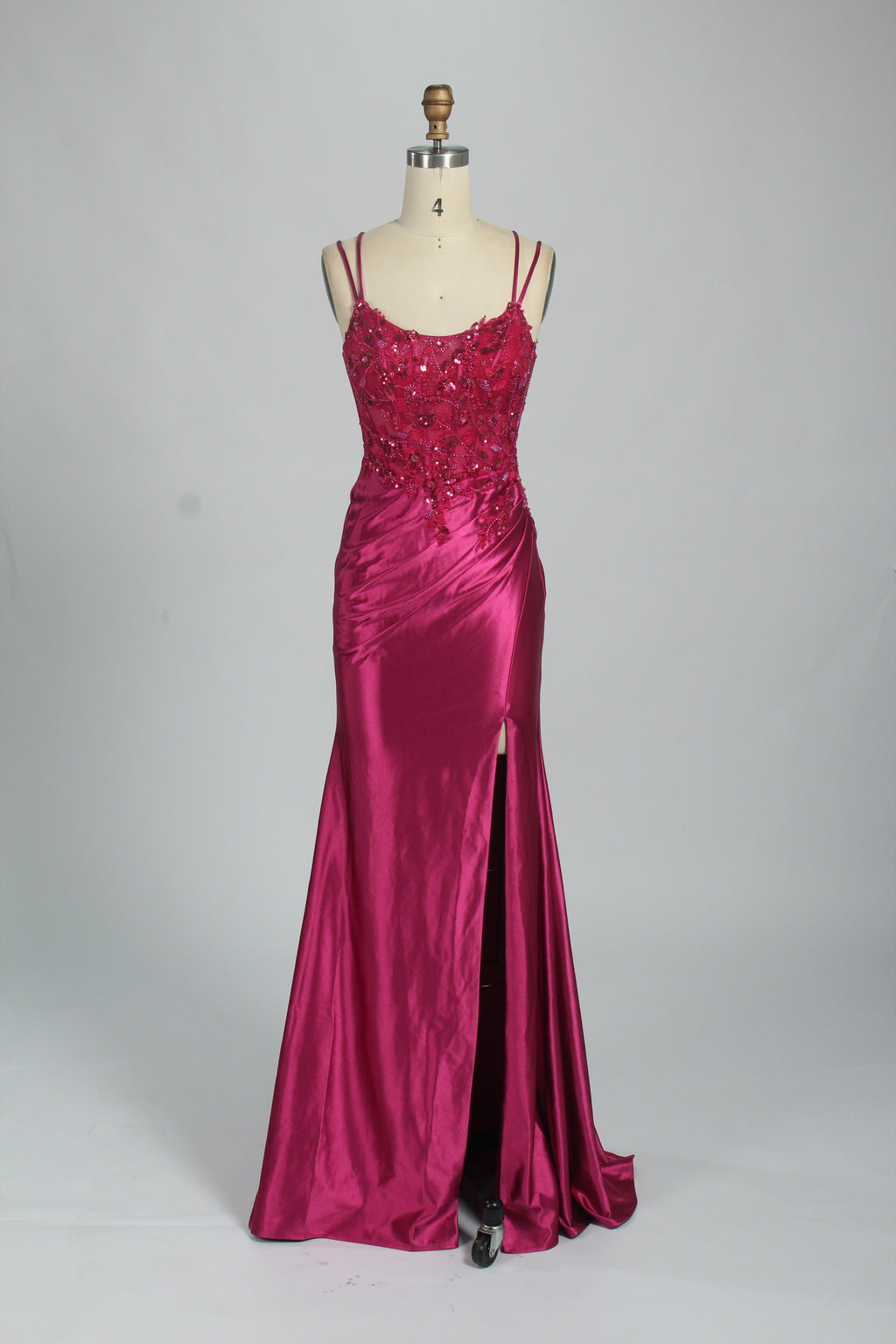 This is a floor - length evening dress in a deep navy hue. It has a strapless style with thin shoulder straps. The bodice is embellished with delicate beadwork and embroidery, creating an elegant and glamorous look. The skirt is form - fitting around the hips and flows down to the floor, featuring a side slit that adds allure and allows for easy movement. Displayed on a mannequin against a simple, light - colored backdrop, the dress exudes sophistication, perfect for special occasions like galas or proms.07