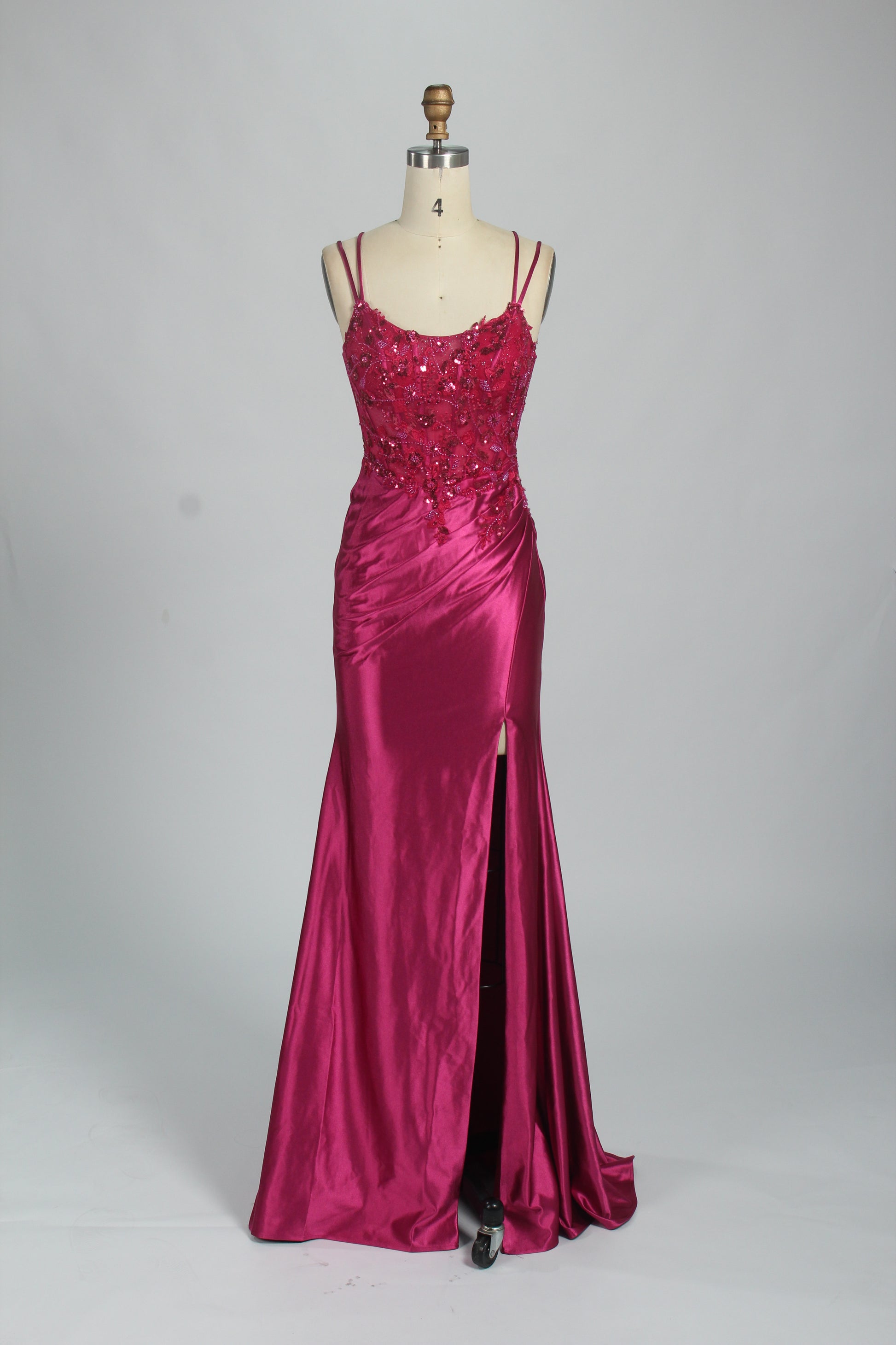 This is a floor - length evening dress in a deep navy hue. It has a strapless style with thin shoulder straps. The bodice is embellished with delicate beadwork and embroidery, creating an elegant and glamorous look. The skirt is form - fitting around the hips and flows down to the floor, featuring a side slit that adds allure and allows for easy movement. Displayed on a mannequin against a simple, light - colored backdrop, the dress exudes sophistication, perfect for special occasions like galas or proms.07