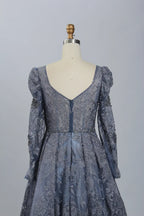 Dark blue beaded illusion V-neck dress with long puff sleeves and fitted bodice