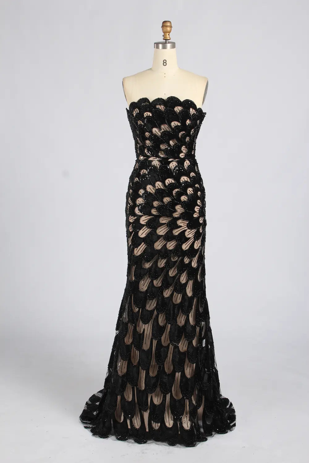 Strapless mermaid evening dress with black sequin feather pattern and gold-tone accents