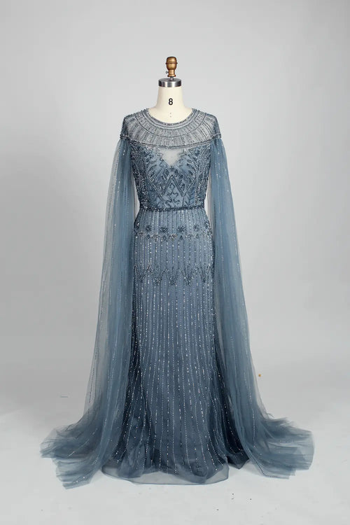 Dusty blue beaded A-line dress with long sleeves, lace yoke, and sheer cape overlay