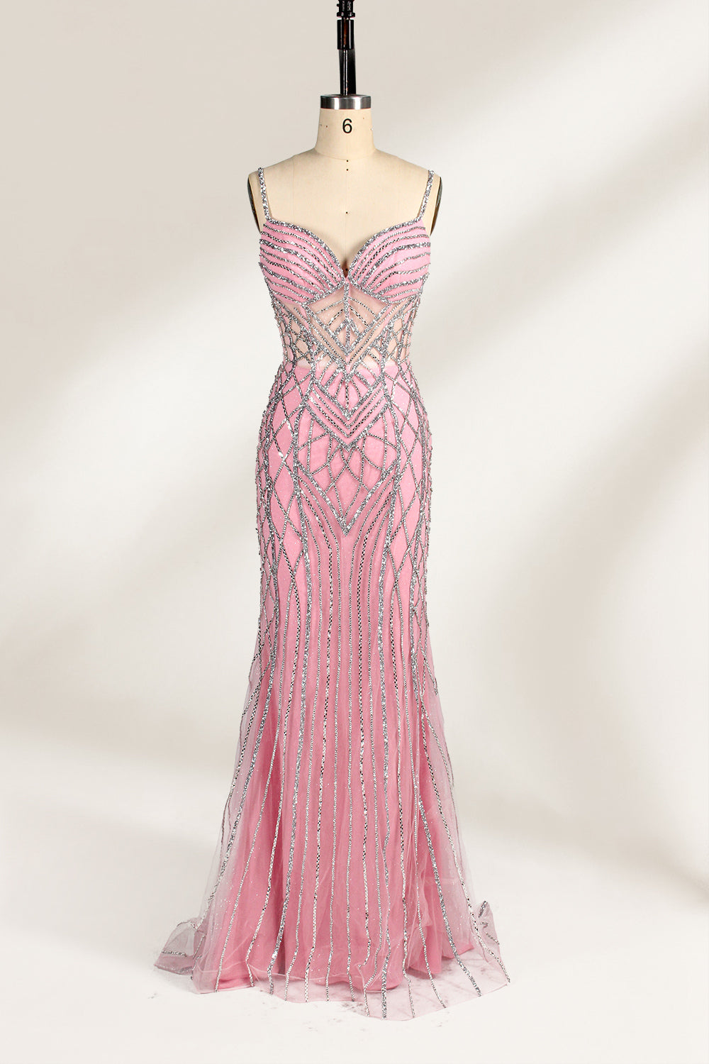 A mannequin presents a pink tulle gown with silver sequin embroidery against a light backdrop. It boasts thin straps, a sheer bodice with geometric patterns, and a mermaid - style skirt. The shimmering sequins and intricate design make it a standout choice for proms or formal events.5
