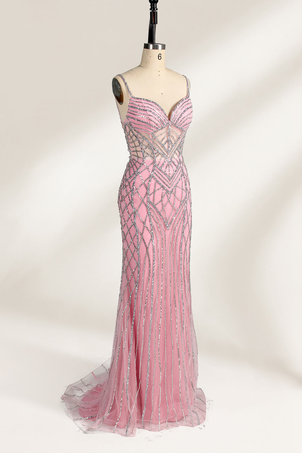 A mannequin presents a pink tulle gown with silver sequin embroidery against a light backdrop. It boasts thin straps, a sheer bodice with geometric patterns, and a mermaid - style skirt. The shimmering sequins and intricate design make it a standout choice for proms or formal events.6