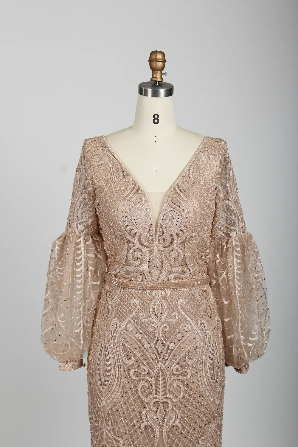 Beaded V-neck A-line cape gown in nude blush with ornate geometric lace sleeves