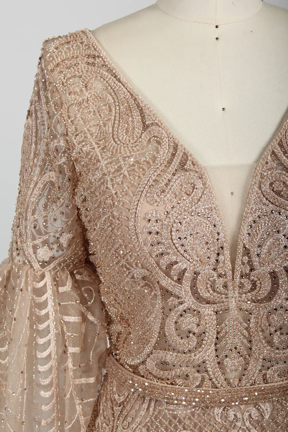 Beaded V-neck cape bodice in nude blush with ornate geometric embroidery detail