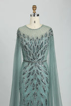 Teal beaded illusion yoke tulle cape mermaid dress with long sleeves