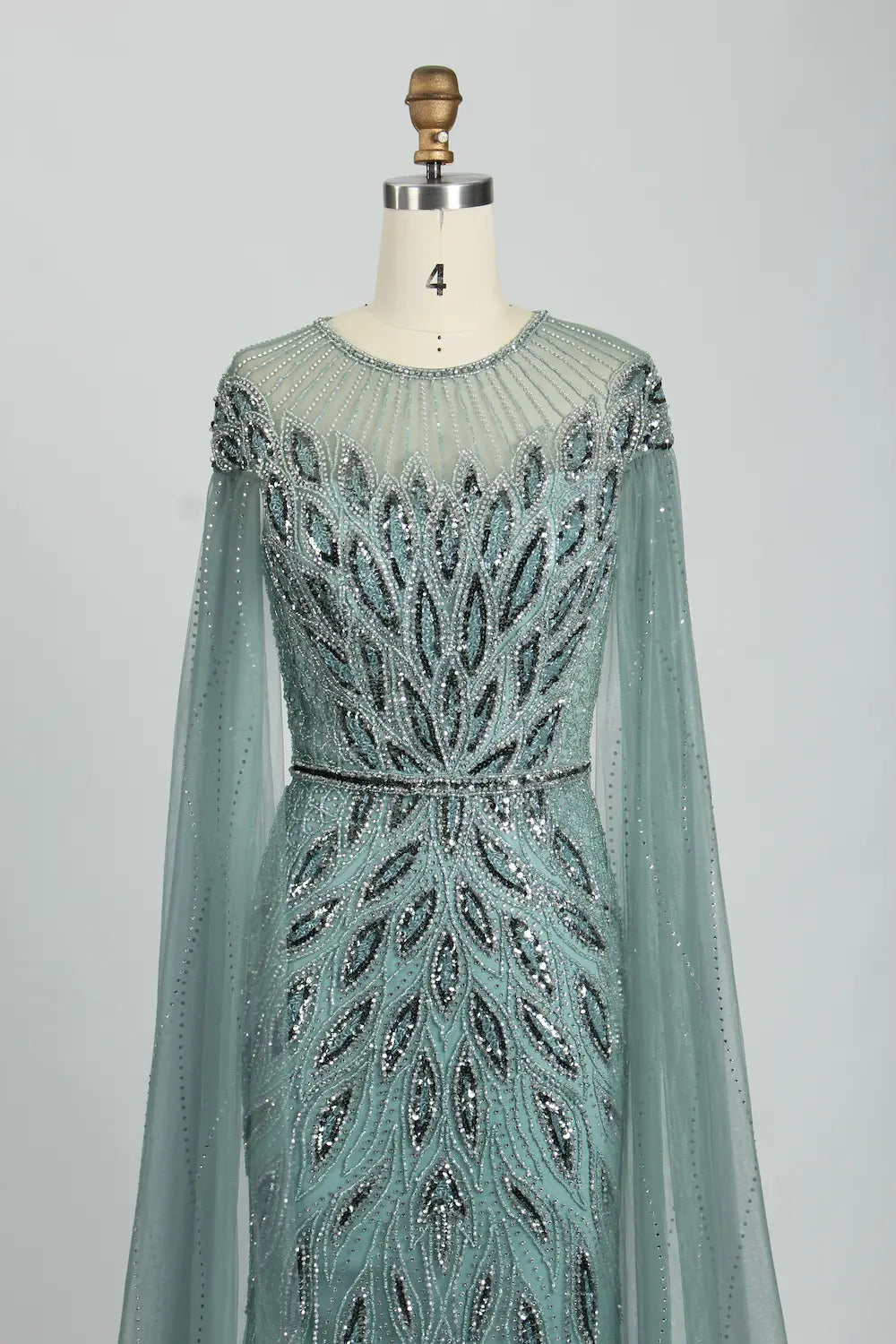 Teal beaded illusion yoke tulle cape mermaid dress with long sleeves