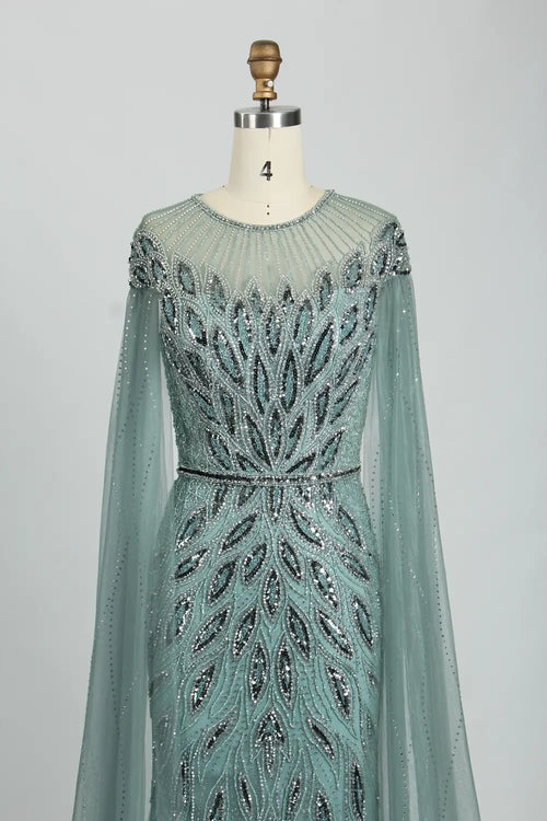 Teal beaded illusion yoke tulle cape mermaid dress with long sleeves