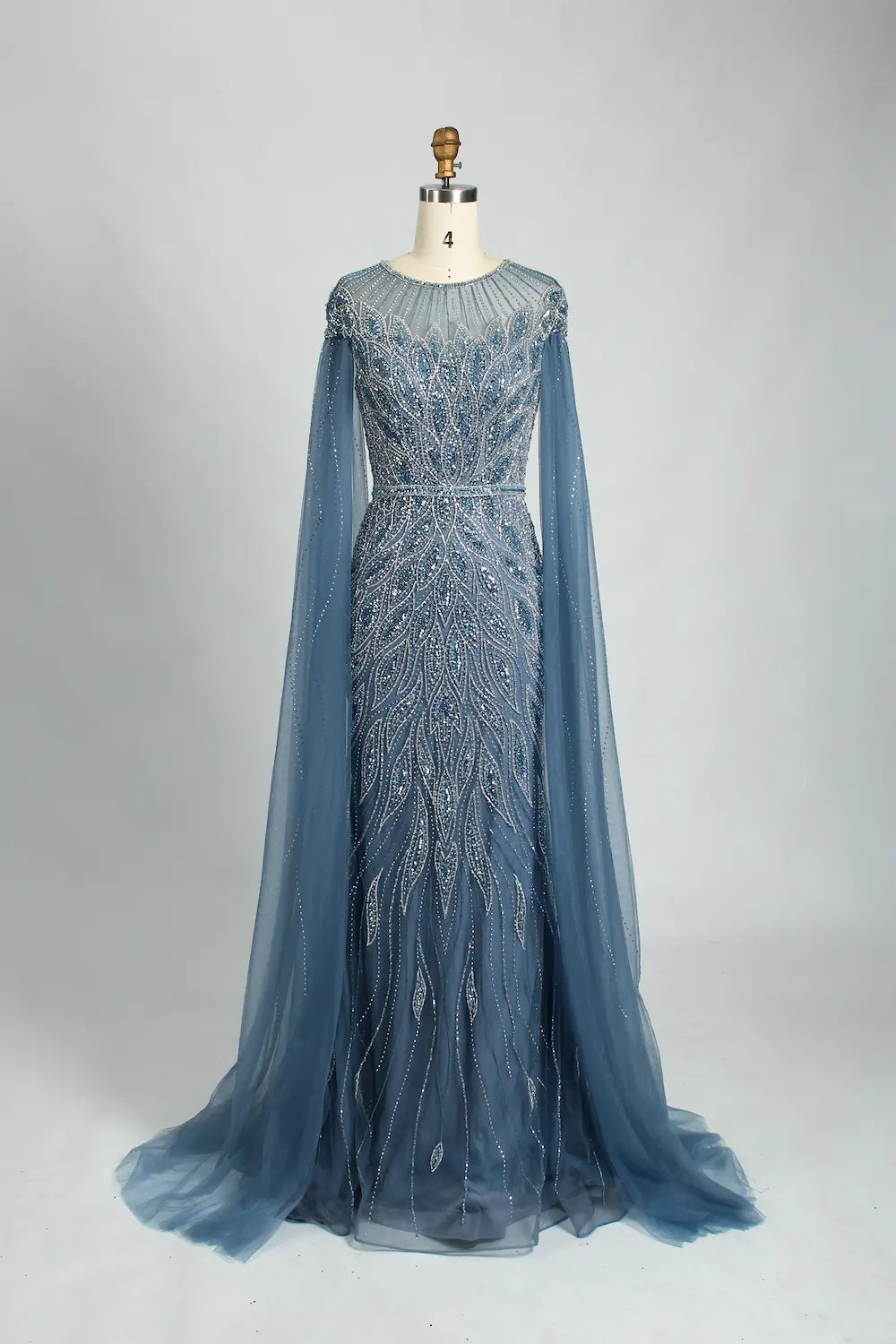 Blue beaded tulle cape mermaid evening dress with long sleeves and flowing skirt
