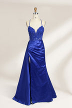 A mannequin showcases a royal - blue gown with thin straps. The bodice features intricate bead embroidery and sheer panels, while the skirt has a ruched design and a high side slit. The satin fabric and elegant details make it perfect for formal events like proms or galas, exuding sophistication.12