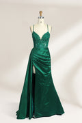 A mannequin showcases a royal - blue gown with thin straps. The bodice features intricate bead embroidery and sheer panels, while the skirt has a ruched design and a high side slit. The satin fabric and elegant details make it perfect for formal events like proms or galas, exuding sophistication.1