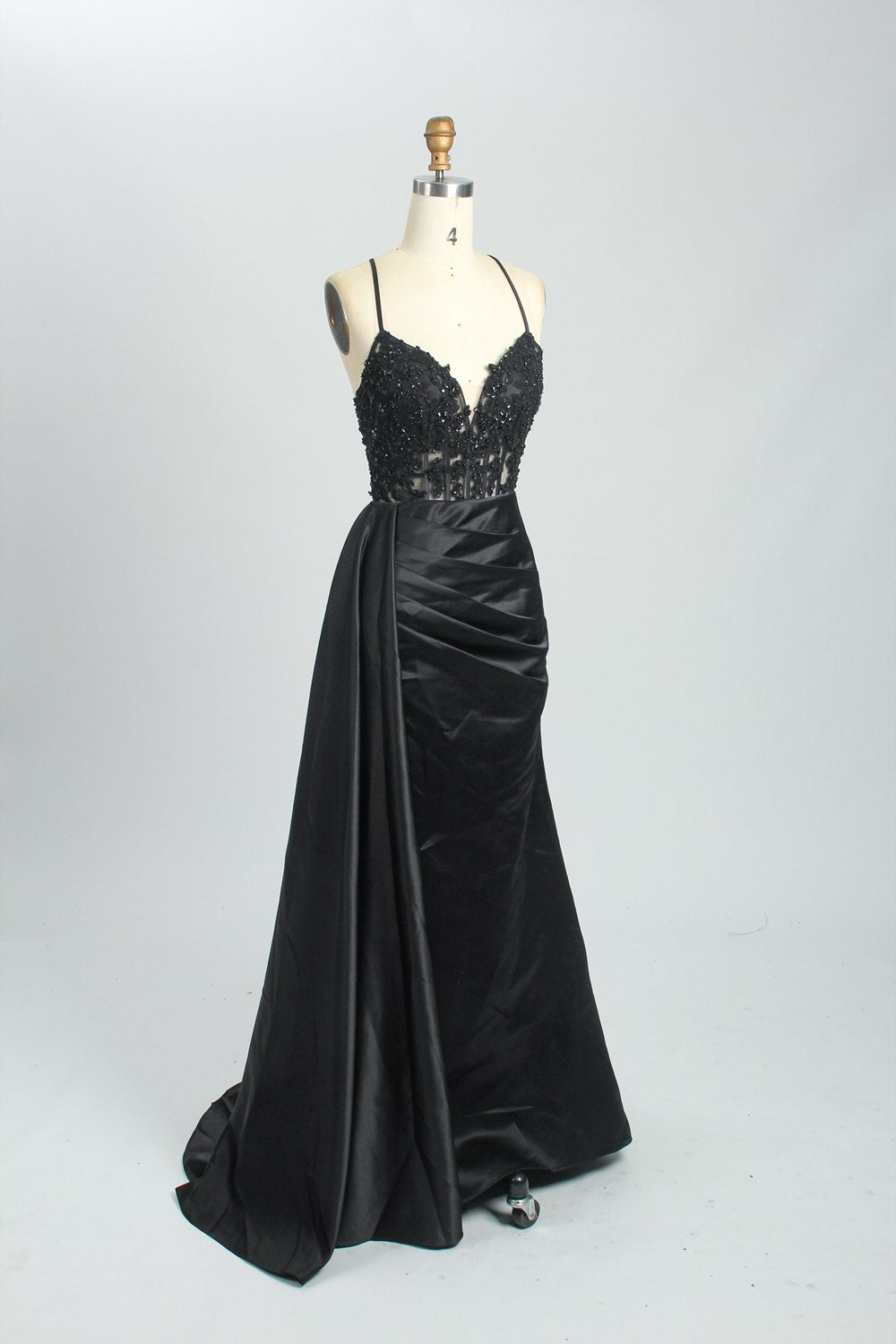 A mannequin showcases a royal - blue gown with thin straps. The bodice features intricate bead embroidery and sheer panels, while the skirt has a ruched design and a high side slit. The satin fabric and elegant details make it perfect for formal events like proms or galas, exuding sophistication.4