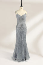 Set against a light background, a mannequin presents a grey tulle gown. It has thin straps, a sweetheart neckline, and a mermaid - shaped skirt. The detailed silver bead embroidery creates an elegant pattern, making it ideal for formal events like proms, radiating sophistication.1