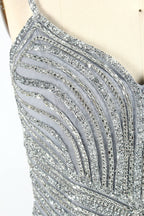 Set against a light background, a mannequin presents a grey tulle gown. It has thin straps, a sweetheart neckline, and a mermaid - shaped skirt. The detailed silver bead embroidery creates an elegant pattern, making it ideal for formal events like proms, radiating sophistication.