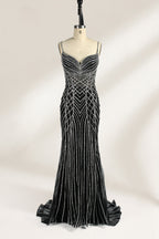 Set against a light background, a mannequin presents a black tulle gown with silver - toned beaded embellishments. Thin straps, a sweetheart neckline, and a mermaid - style skirt complete the look. The geometric bead patterns add a touch of glamour, ideal for proms or formal events where the beaded artistry stands out.1