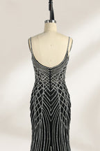 Set against a light background, a mannequin presents a black tulle gown with silver - toned beaded embellishments. Thin straps, a sweetheart neckline, and a mermaid - style skirt complete the look. The geometric bead patterns add a touch of glamour, ideal for proms or formal events where the beaded artistry stands out.3