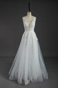 This wholesale wedding dress showcases intricate beaded lace on a sheer bodice, featuring a deep V - neckline for a touch of allure. The flowing tulle skirt, adorned with delicate lace patterns, creates a dreamy and romantic silhouette. The open back design adds to its charm. Crafted for brides seeking elegance and sophistication, it’s an ideal choice for creating unforgettable wedding moments. Bridal shops can stock up on bulk orders to offer this exquisite, eye - catching gown to their customers.01