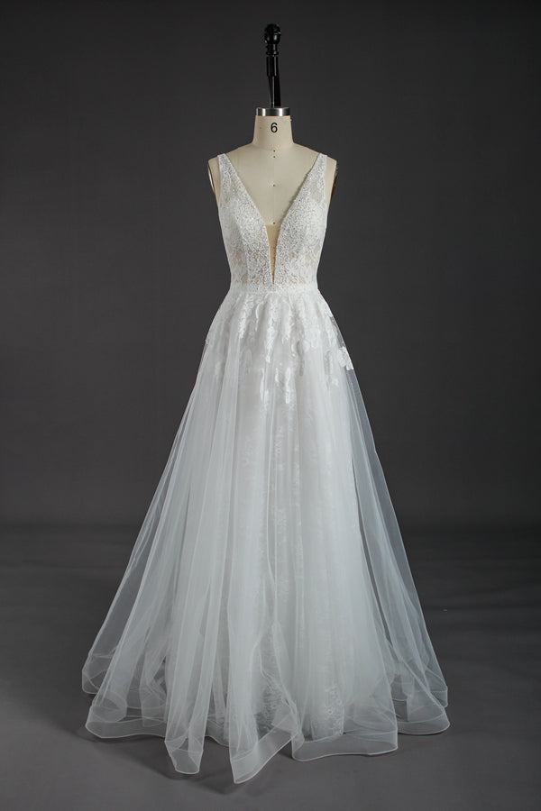 This wholesale wedding dress showcases intricate beaded lace on a sheer bodice, featuring a deep V - neckline for a touch of allure. The flowing tulle skirt, adorned with delicate lace patterns, creates a dreamy and romantic silhouette. The open back design adds to its charm. Crafted for brides seeking elegance and sophistication, it’s an ideal choice for creating unforgettable wedding moments. Bridal shops can stock up on bulk orders to offer this exquisite, eye - catching gown to their customers.01