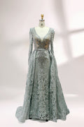 Displayed on a mannequin is a light - gray evening gown. It has a deep V - neckline, long sleeves, and intricate lace embroidery with a grid pattern. The elegant design gives off a luxurious and sophisticated vibe, ideal for formal occasions.1