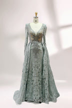 Displayed on a mannequin is a light - gray evening gown. It has a deep V - neckline, long sleeves, and intricate lace embroidery with a grid pattern. The elegant design gives off a luxurious and sophisticated vibe, ideal for formal occasions.1