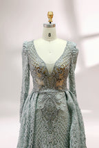 Displayed on a mannequin is a light - gray evening gown. It has a deep V - neckline, long sleeves, and intricate lace embroidery with a grid pattern. The elegant design gives off a luxurious and sophisticated vibe, ideal for formal occasions.8