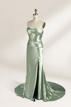 A mannequin showcases a strapless light - green satin gown against a soft, neutral backdrop. The dress features a twisted, criss - cross bodice with a subtle sheer panel and a mermaid silhouette, complete with a high side slit and a flowing train. The smooth, lustrous satin fabric and elegant design exude sophistication, perfect for formal galas or black - tie events.3