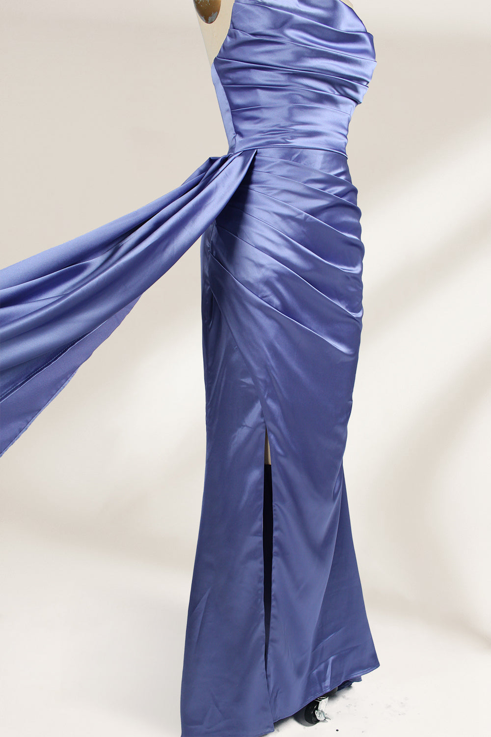 A strapless, lavender - blue satin evening gown is displayed on a mannequin. It features a draped bodice, ruched detailing on the skirt, a high side slit, and a flowing train, creating an elegant and graceful look, suitable for formal occasions.4