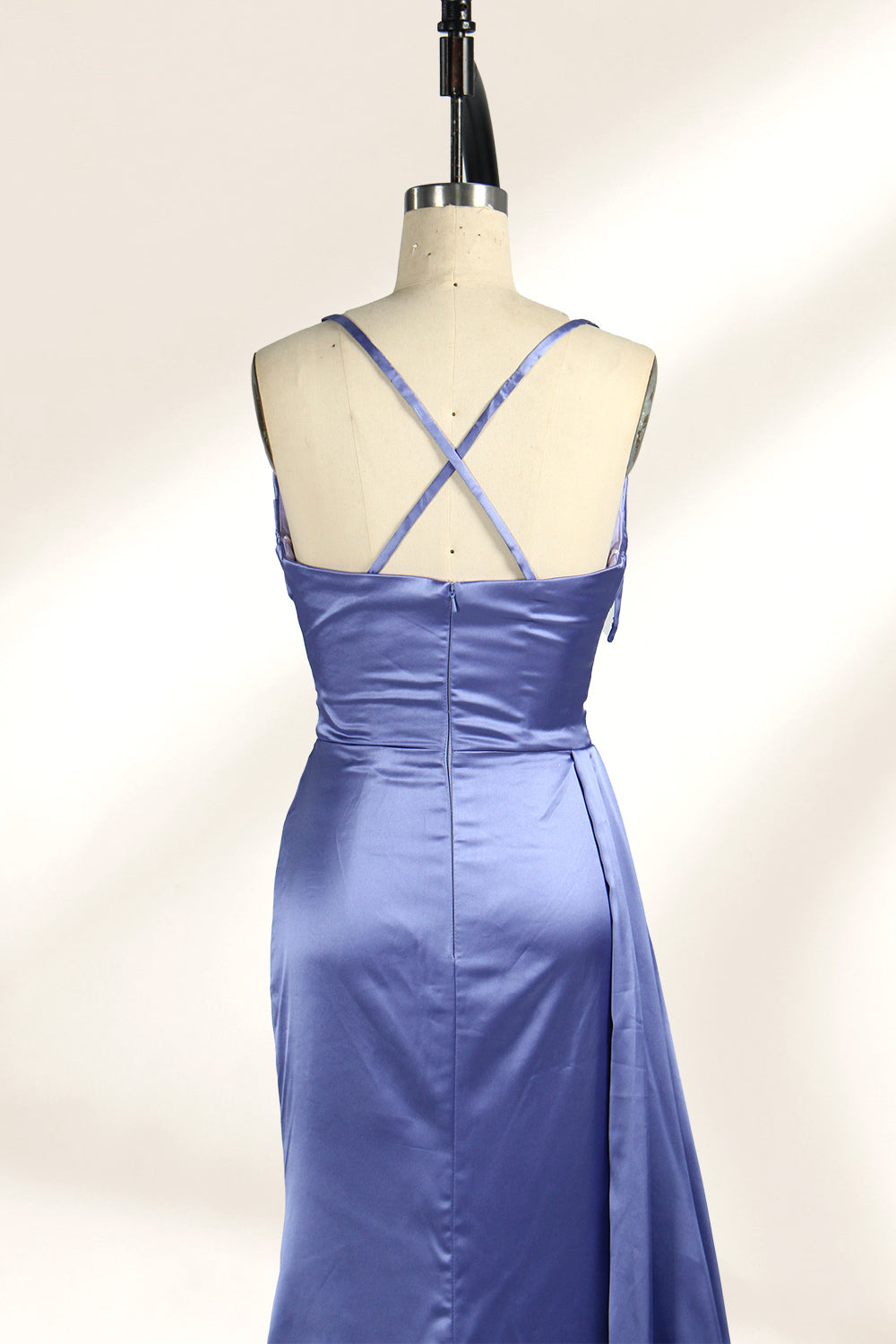 A strapless, lavender - blue satin evening gown is displayed on a mannequin. It features a draped bodice, ruched detailing on the skirt, a high side slit, and a flowing train, creating an elegant and graceful look, suitable for formal occasions.5