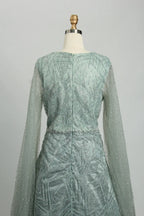 Teal beaded A-line dress with long sheer sleeves and vertical back seam